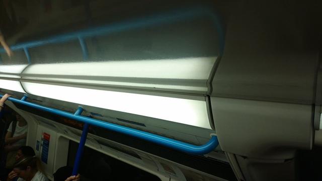 a handrail inside a Victoria line London Underground train, azure blue to match the line's map colour