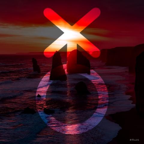 The nonbinary symbol over a picture of an ocean sunset on a rocky beach.
