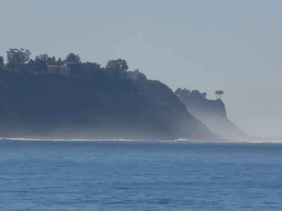Misty cliffs above the sea.