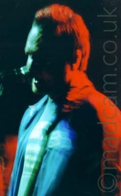Atonal's singer, bathed in coloured lights