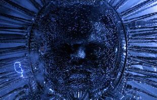 Image from Matrix Revolutions showing 'Deus Ex Machina' character. 'Face' of character formed by thousands of Sentinels moving in formation, to form eyes; nose; and mouth. Looks a little like a baby's face with spines surrounding with lightning sparks jumping from spike to spike as the character speaks.