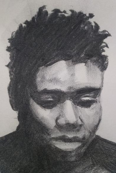 Charcoal portrait of a person with short curly hair - looking down.