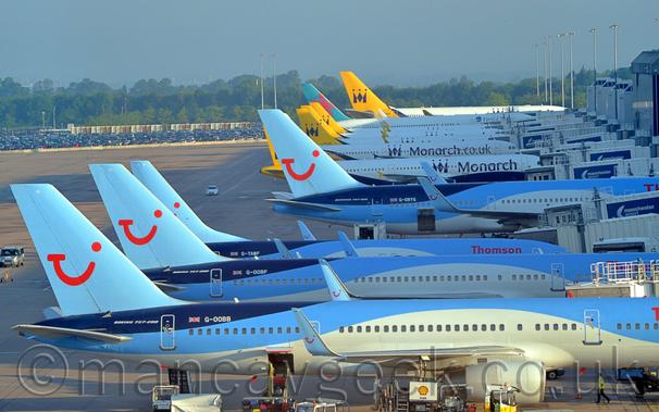 Lineup at Manchester Airport - thomson B757s, B737, and B767, Monarch A321s and A330, and First Choice B767