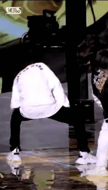 Treasure's Kim Doyoung in a white outfit performing MMM on Inkigayo