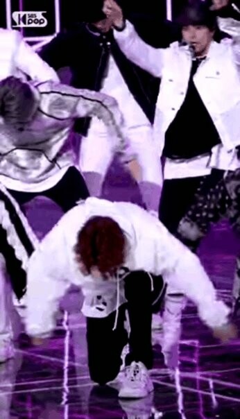 Treasure's Kim Doyoung in a white outfit performing MMM on Inkigayo