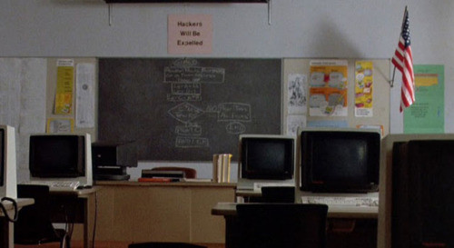 Scene from Breakfast Club in a computer class with a sign that says "Hackers Will Be Expelled"