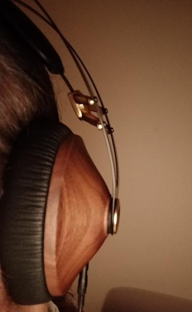 A close-up of one side of the Meze Classics on my head. A solid walnut cup with gold fitings.