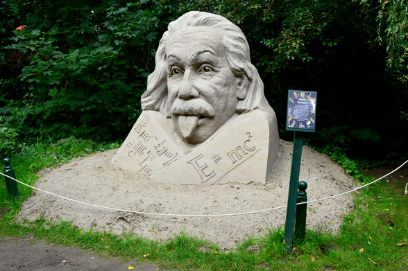 A sand sculpture of Albert Einstein sticking out his tongue.