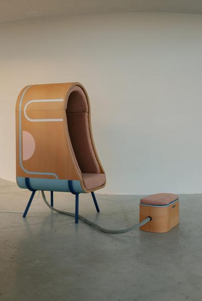 Wooden cocoon chair by Alexia Audrain with footrest