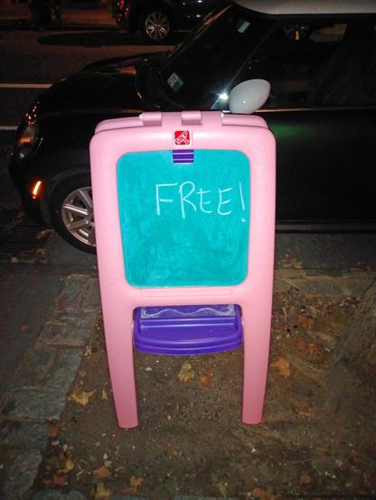 Someone left a children's chalkboard built into a plastic pink easel in a treepit in Cobble Hill, Brooklyn NYC, for the taking. To underscore the point, whoever left it wrote "FREE!" on the chalkboard.