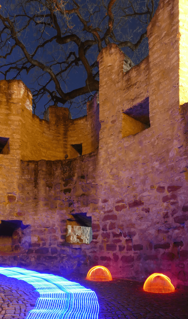 Medieval masonry at night. A bare tree against a blue sky fills the upper third. In front of a wall curving to the left with battlements on it, a multi-lane blue strip of light hovers above the paved path at knee height. To the right are two red light hemispheres.