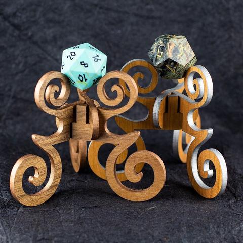 Laser-cut Celtic-themed wooden dice "reliquary" display stands shown with turquoise and crocodile jasper polyhedral dice.
