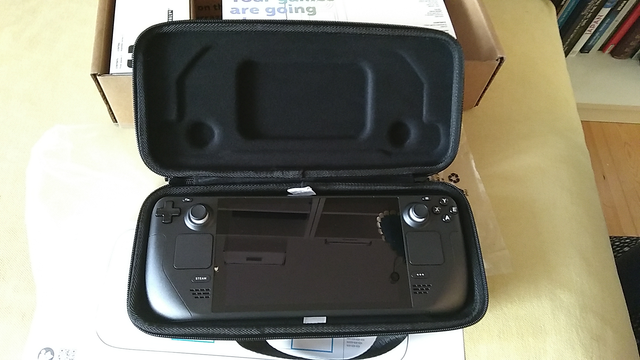 A brand new steam deck in its carrying case.