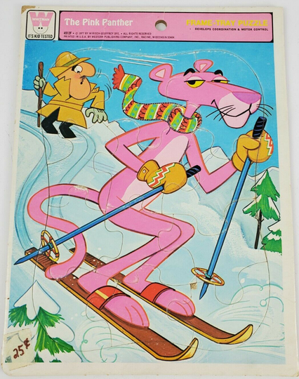This is a Frame Tray Puzzle. 
The Pink Panther is central to the image. He is on skis, holding ski poles, wearing mittens and a scarf. He's skiing down hill. 
The Inspector is in the top left of the image and he's looking concerned because the Pink Panther's ski tracks are on both sides of him.