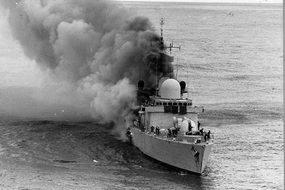 D80 Type 42 destroyer HMS Sheffield on fire in the Argentine Sea.