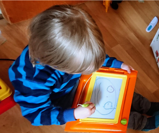 BeardGrabber holding the sketch board on his lap as he's fixing up the drawing by drawing the missing lines back in.
