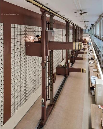 The Central Social Institution of Prague. 

A vast hall in which banks of file drawers 25 high and about 20 across are arranged into 10 banks, each fronted by a desk which can move vertically and horizontally to 7 or 8 meters off the floor, strongly resembling the flying desks in Futurama (though the inspiration doubtless runs the other direction).

There are 3,000 drawers in total, covering 4,000 square feet (370 m^2).

The effective data storage is on the order of a few hundred GB.  You could fit the same on your thumbnail today.

The structure was opened in 1937.