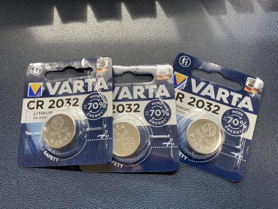 3 Varta CR2032 lithium batteries in their original blister packaging spread out on my desk.