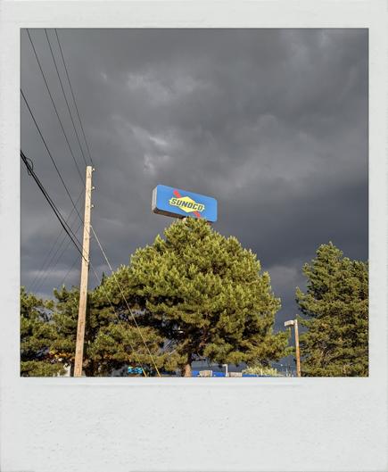Exterior Sunoco sign against gray clouds