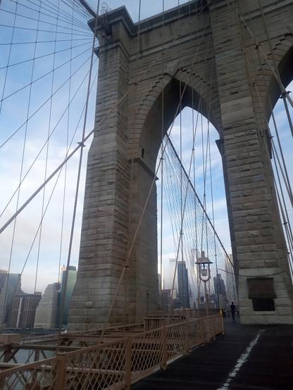 Photo taken from the Brooklyn Bridge of the Manhattan skyline early on the morning of September 12, 2022. The Freedom Tower is framed by the arch of the first of two Brooklyn Bridge towers from the Brooklyn side.