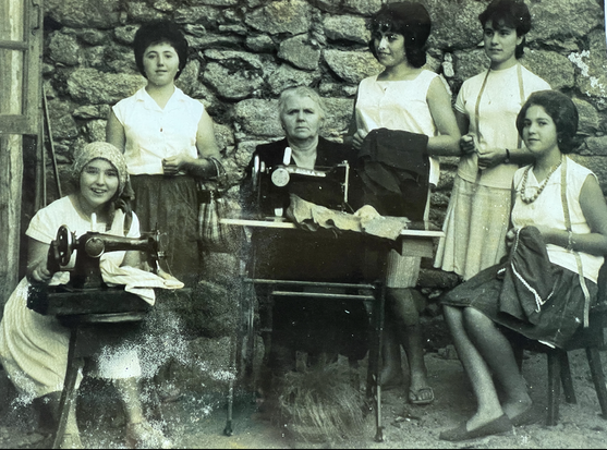 Photograph of women sewing, in Laxe, mid-20th century. Black and white.