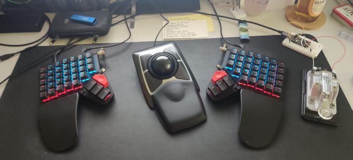 ZSA Moonlander split keyboard with Kensington Trackball and straight Morse key.