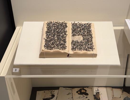 Khalil Rabah (born Jerusalem, 1961)
Dictionary work, 1997.

An English dictionary is covered with nails obliterating all but the word Phi.lis. tine defined as 'inhabitant of ancient Philistia (Palestine): a no materialistic person; esp, one who or is smugly indifferent to intellectual or kori artistic values. Art historian Angit Ankori wrote: from afar the nails that penetrate the dictionary seem jewel-like, since they glisten with deceiving sheen.