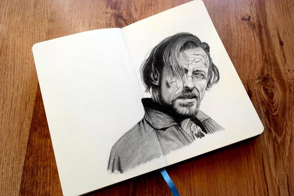A pencil portrait of a man in a 3/4 angle looking rough and with his hair falling into his face.