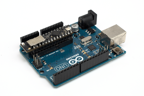 The Jolly Module installed in an Arduino Uno microcontroller board. seen at an isometric angle on a white background. While the Jolly Module's labelling is the correct way up to the observer, the Arduino Uno's labelling is upside down.