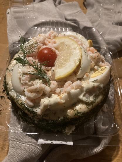 A cake like sandwich with schrimp and egg, tomato and dill.
A very Swedish thing.
