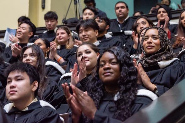 grads clap during convocation ceremony