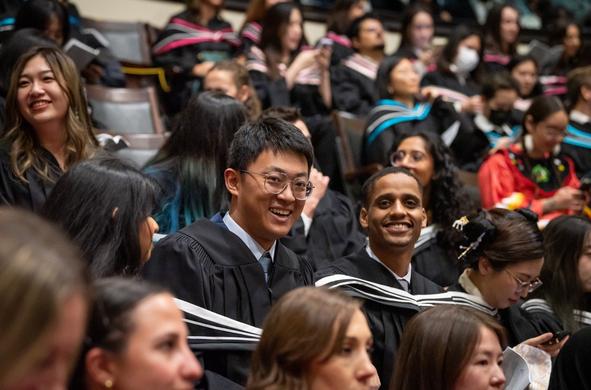 grads laugh during convocation ceremony