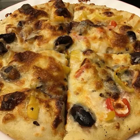 White pan pizza with kalamata olives and pickled sweet peppers.
