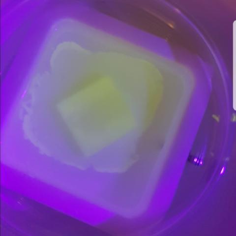 Photography of a luminescent nanoparticle film floating on a liquid subphase under UV irradiation