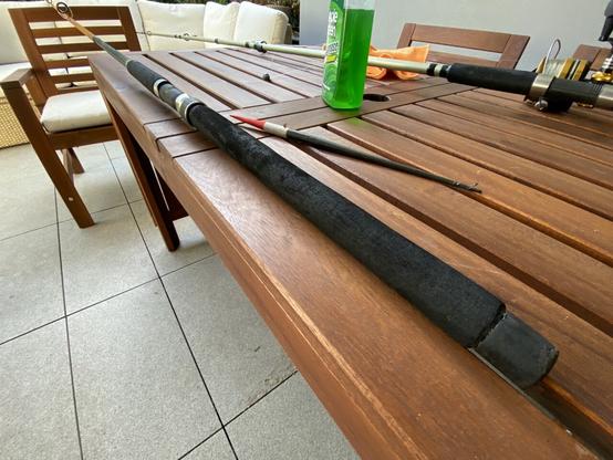 The handle end of the rod, black foam rubber grip. Looks pretty beat up but clean. Next to it sits a float of similar vintage