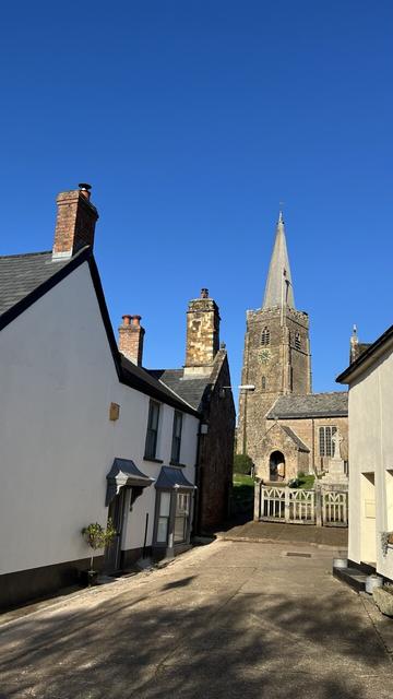 View of a church draped in the blue-est of blue skies