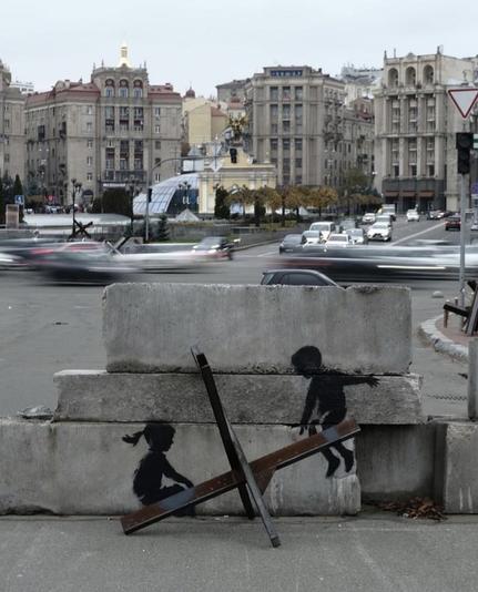 Two children ‘seesaw’ upon x shaped road blockade in Kyiv