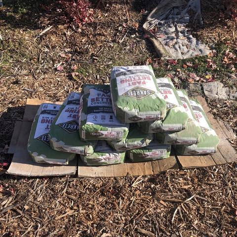10 bags of cement, 50lbs each, stacked into a pyramid