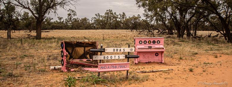 In the middle nowhere, in outback NSW you can find a site titled "Bras, Boots and Pink Pianos" These are plonked by the roadside, the pianos 2 of, are the old upright variety, decorated with vinyl records. In the background is a tree strewn with offcast bras, whilst beside is a tree decorated with many types of boots and shoes from large to tiny.