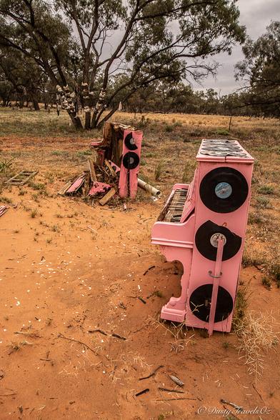 In the middle nowhere, in outback NSW you can find a site titled "Bras, Boots and Pink Pianos" These are plonked by the roadside, the pianos 2 of, are the old upright variety, decorated with vinyl records. In the background is a ree strewn with offcast bras, whilst beside is a tree decorated with many types of boots and shoes from large to tiny.