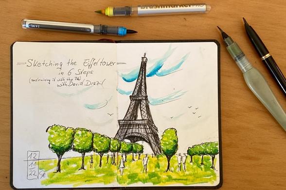 Marker coloured ink sketch of the Eiffeltower with trees and some people in the foreground- and a much too green meadow.
Around the sketchbook are some of the used pencils.
