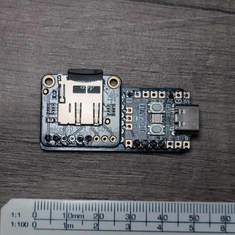 TinyCPM board - Pimoroni Tiny2040 and Adafruit SD Card breakout board on a single board.  Ruler shown for scale.