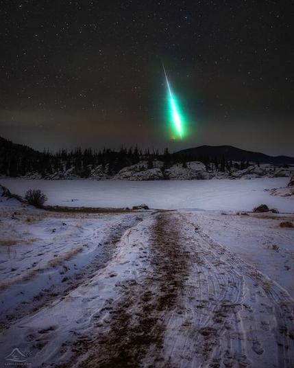 Meteor  in sky, taken in Colorado in Nov 2020. Green streak low in the horizon with snow on the ground