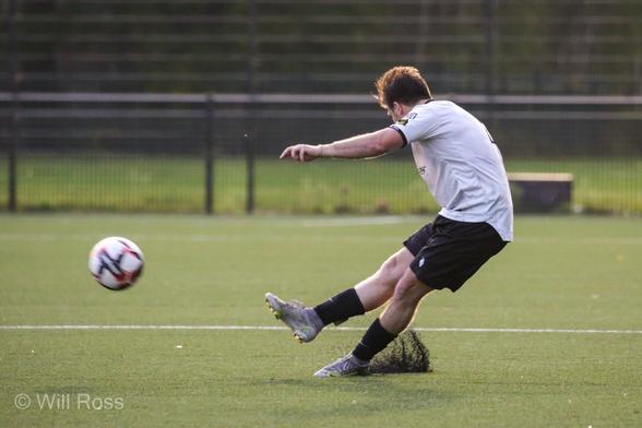 Balham no 7 Alec launches another diagonal in a cloud of rubber dust from the 3G pitch