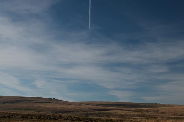Open moor and sky with a single con trail