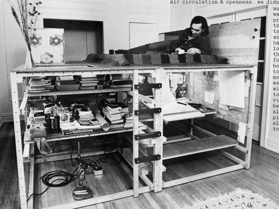 A large platform loft bed with someone ontop made from the modular wood used in other projects showcasing how objects can change and reduce waste.