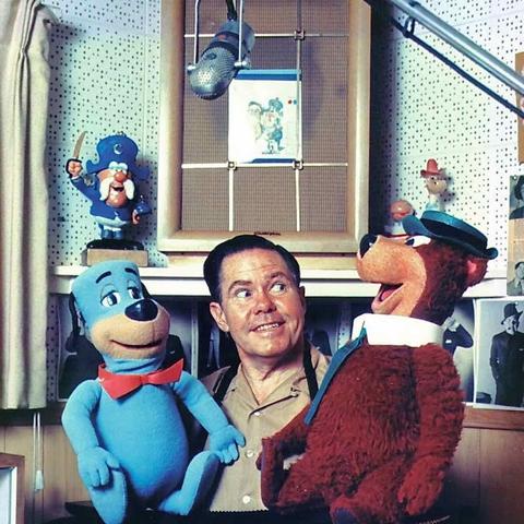 Daws Butler posing with Huckleberry Hound and Yogi Bear.