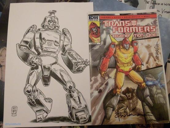 A pic of con loot I bought, from 2015. Art by Stephen Baskerville, with a black & white Blurr piece I got on the left and a signed comics cover for Transformers Regeneration One # 96.

The latter has Rodimus Prime (or Hot Rod, like I remember how they draw them in the comics just now with no access) on the cover. Rodimus is a bit of a favourite. (Sue me.)