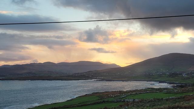 Sunrise with orange and grey clouds over the bay. Zoomed in at the orange part. Clouds look like a curtain.