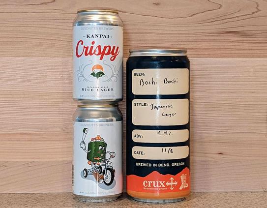 Cans of Deschutes Brewery Kanpai Crispy and a crowler of Crux Fermentation Project Bochi Bochi, both Japanese rice lagers